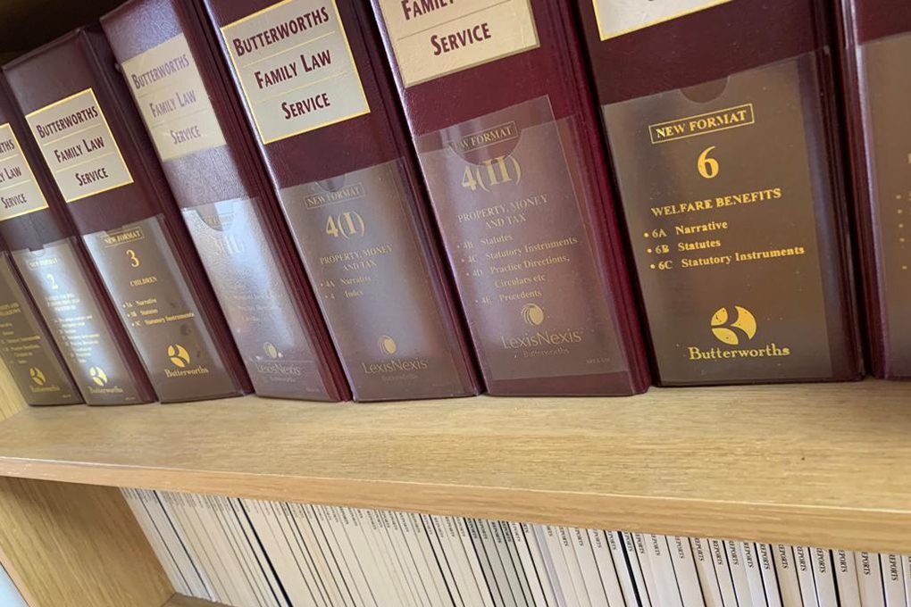 Image of a shelf with legal books and documents