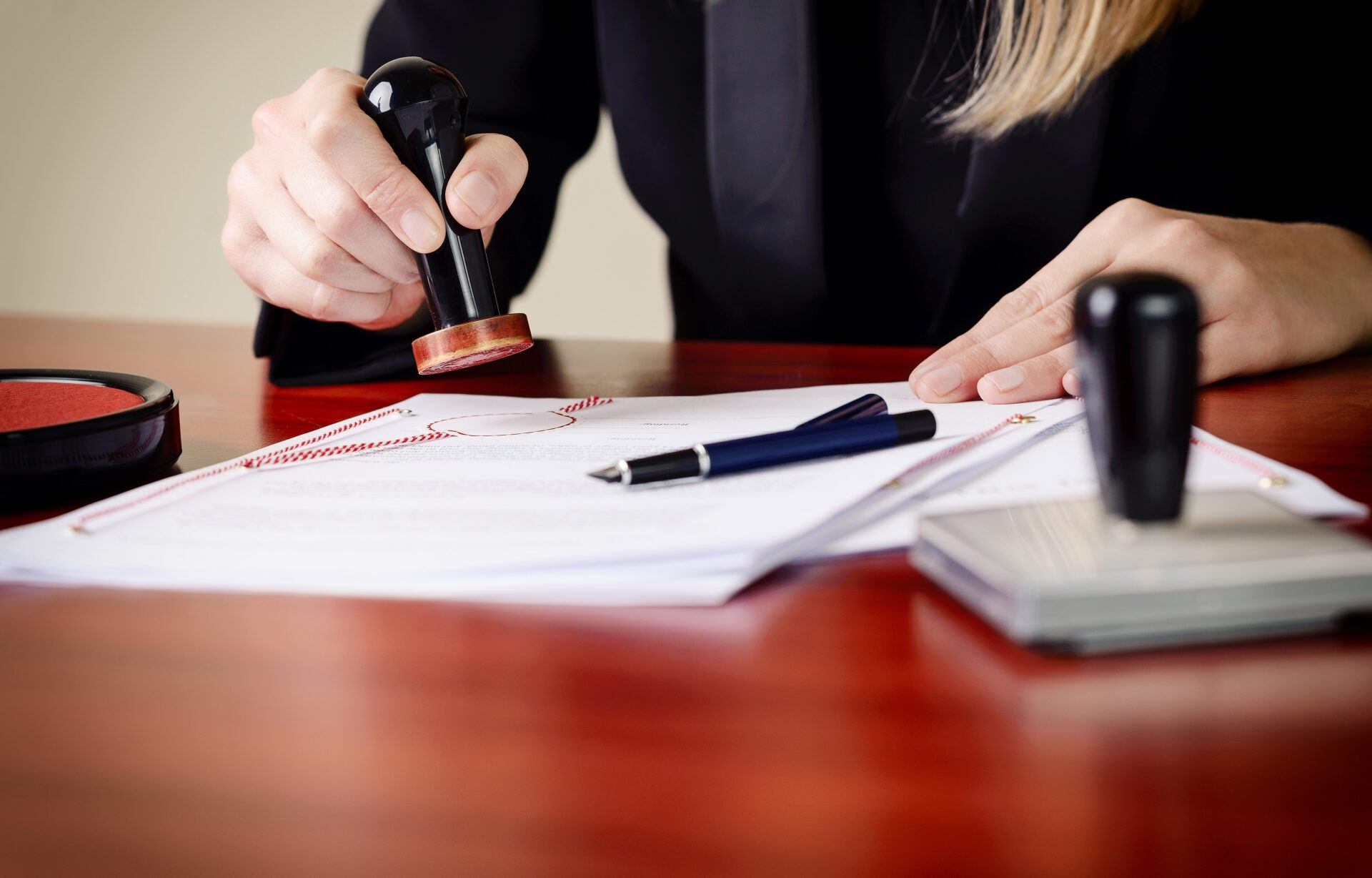 Image of a Notary public stamping a document